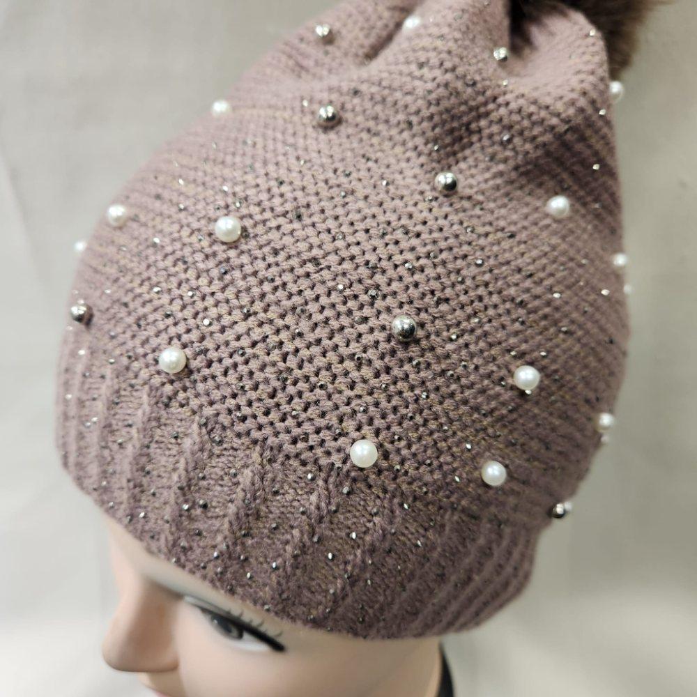 Detailed view of Taupe winter beanie with pom pom