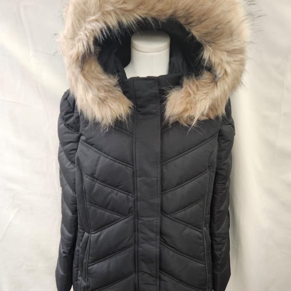 Detailed view of black winter jacket with fur trim