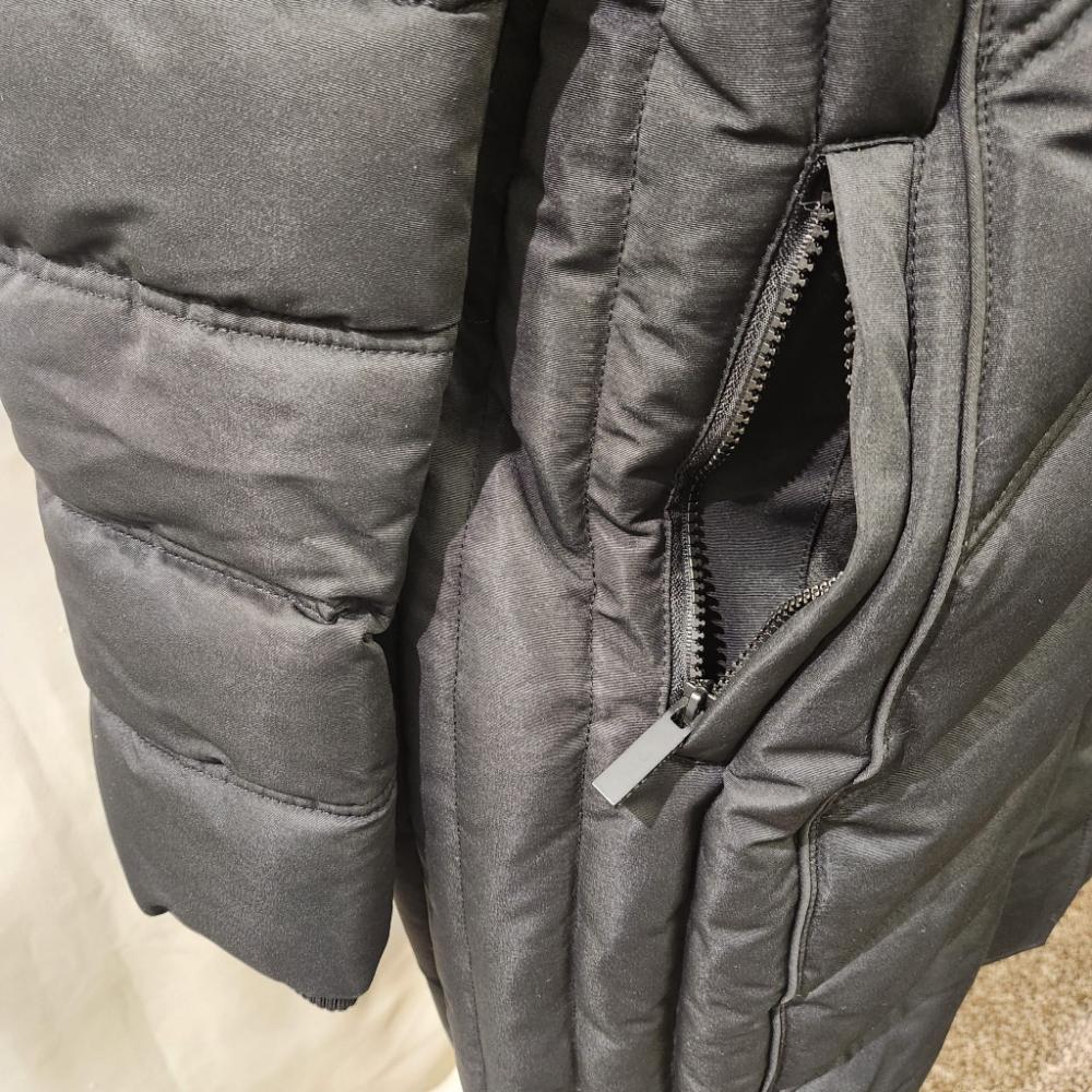 Zipped side pocket of black winter jacket