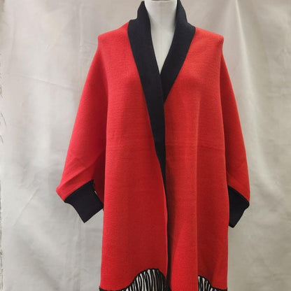Reversible cape with sleeves in red and black with red side up