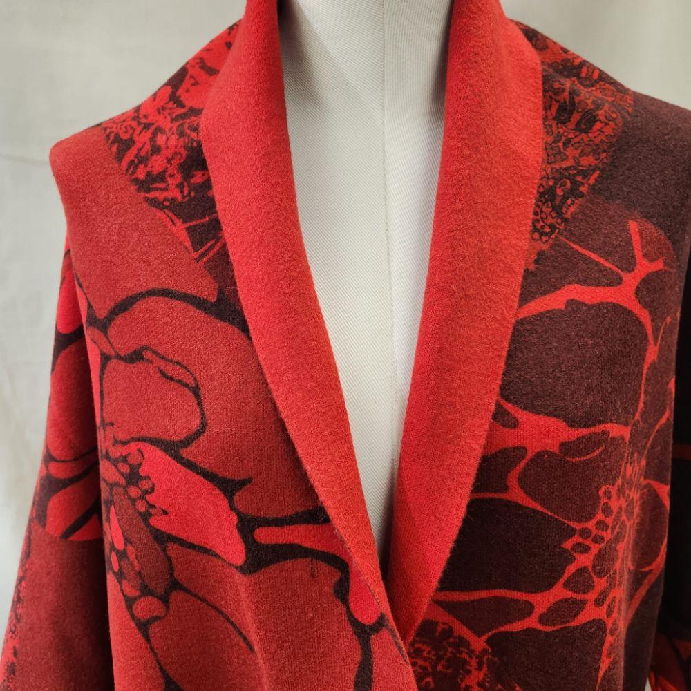 Detailed view of Red and deep burgundy shade printed reversible cape
