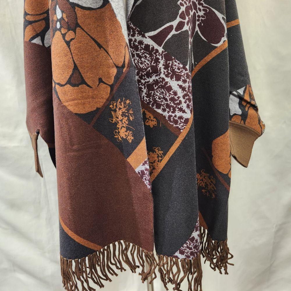 Detailed view of the sleeves of printed reversible cape 