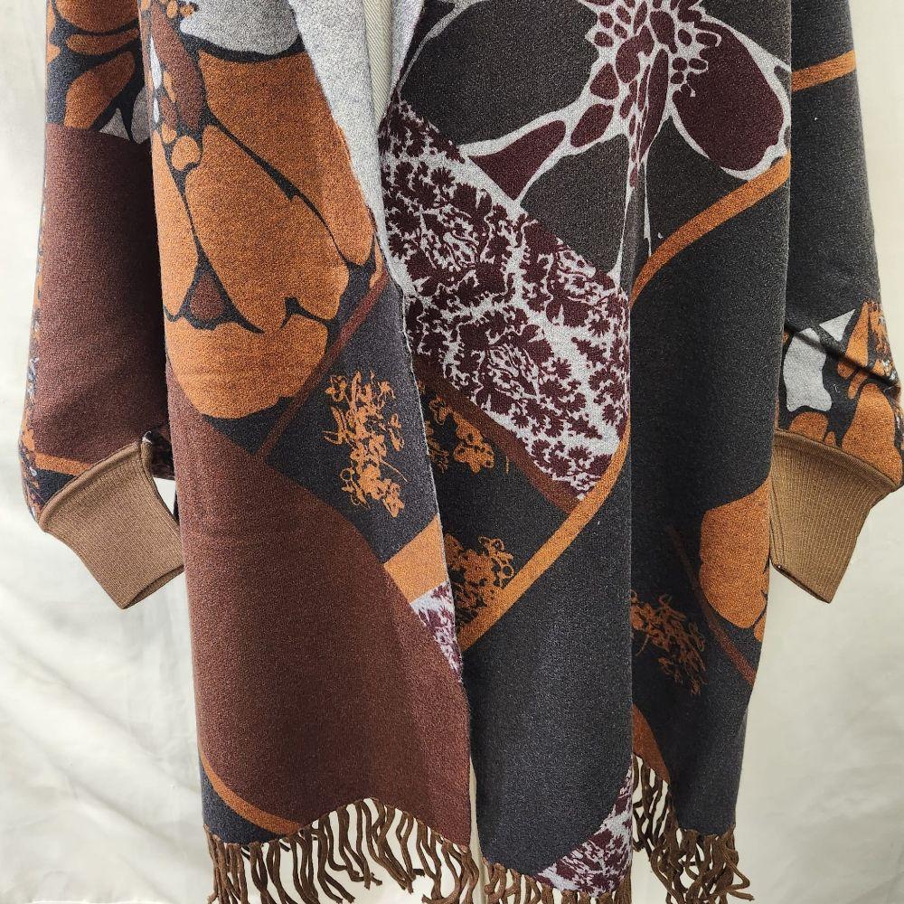 Another view of the sleeves of brown and grey reversible printed cape