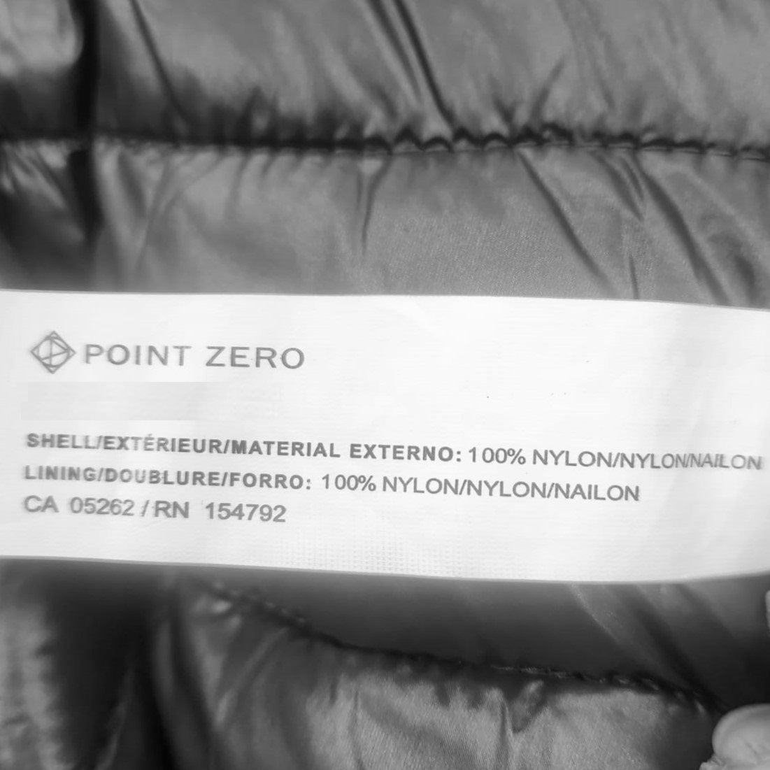 Inside tag regarding shell and lining of black Point Zero spring jacket