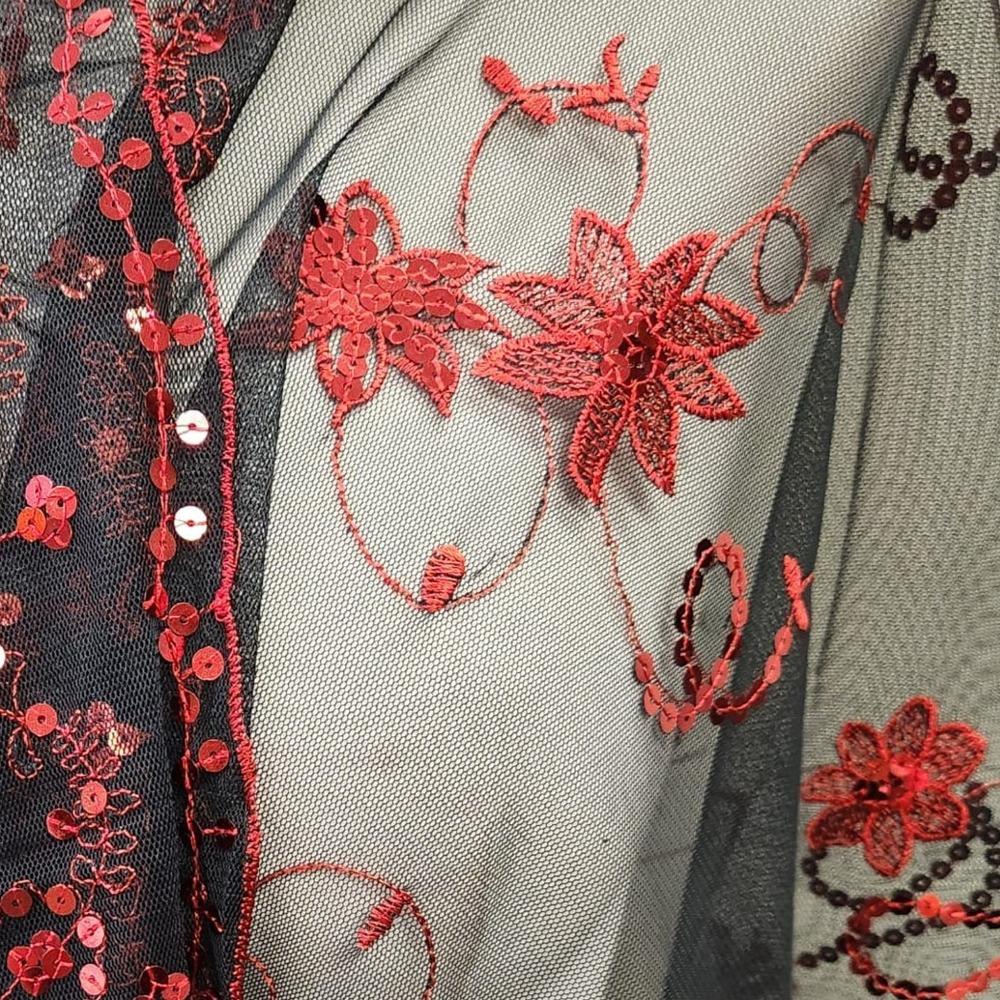 Detailed view of scarf with red embroidery & sequins