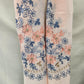 Detailed view of colorful embroidery on light peach summer scarf