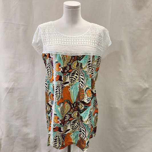 Front view of top in vibrant print and white lace upper