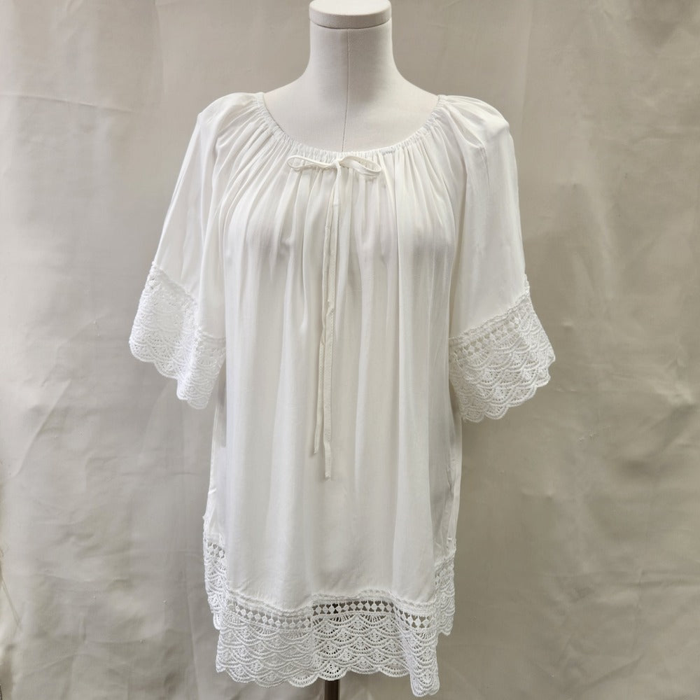 Front view of White top with lace detail and round gathered neckline