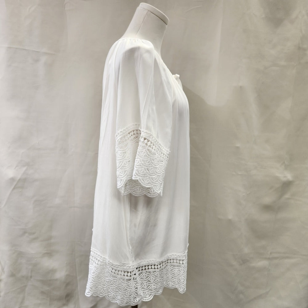 Side view of White top with lace detail and round gathered neckline