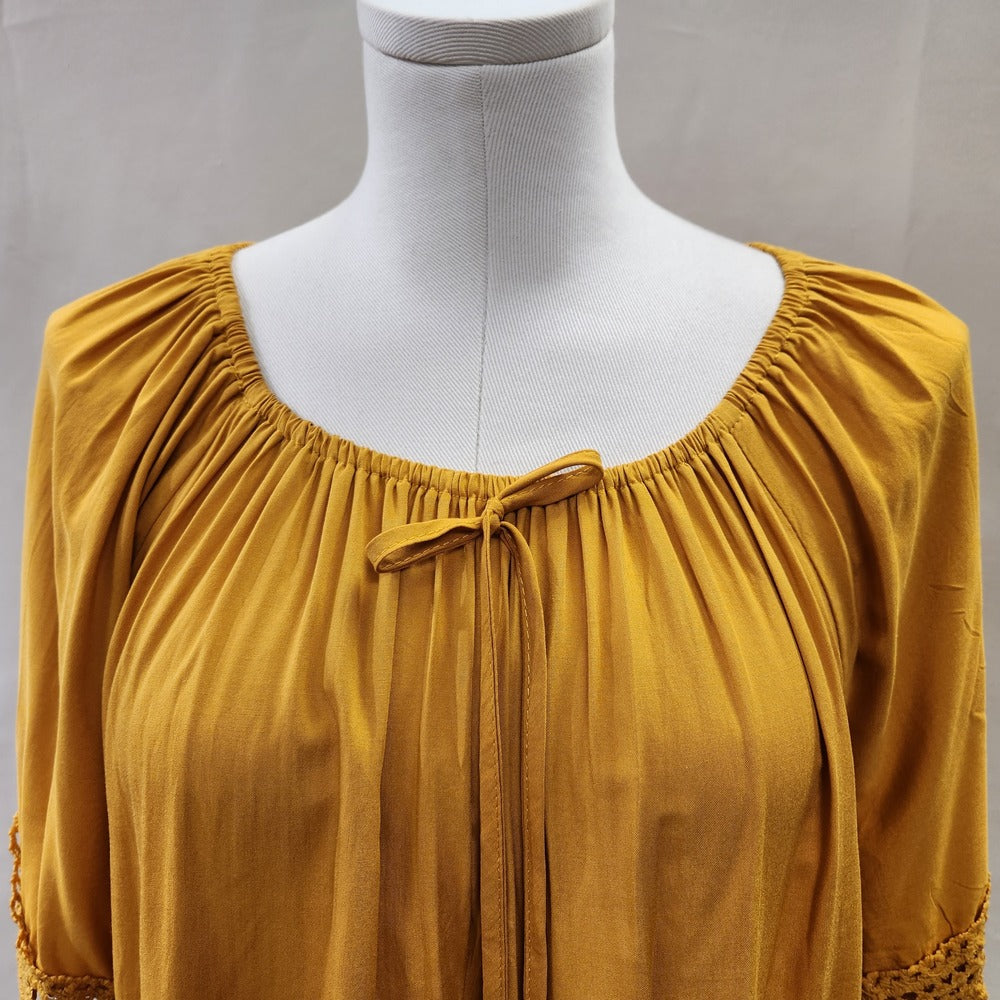 Round gathered neckline of yellow top with elastic 
