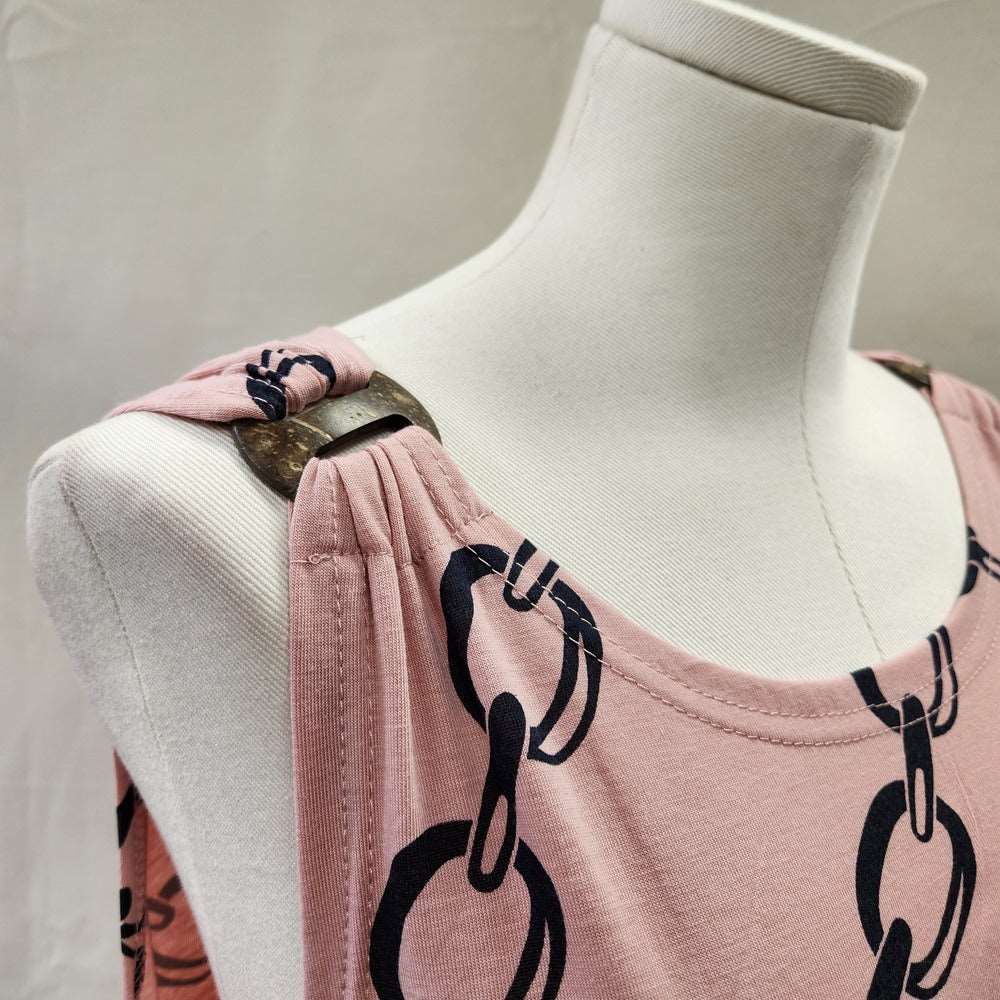 Decorative shoulder detail of Dusty pink top with link chain print in black