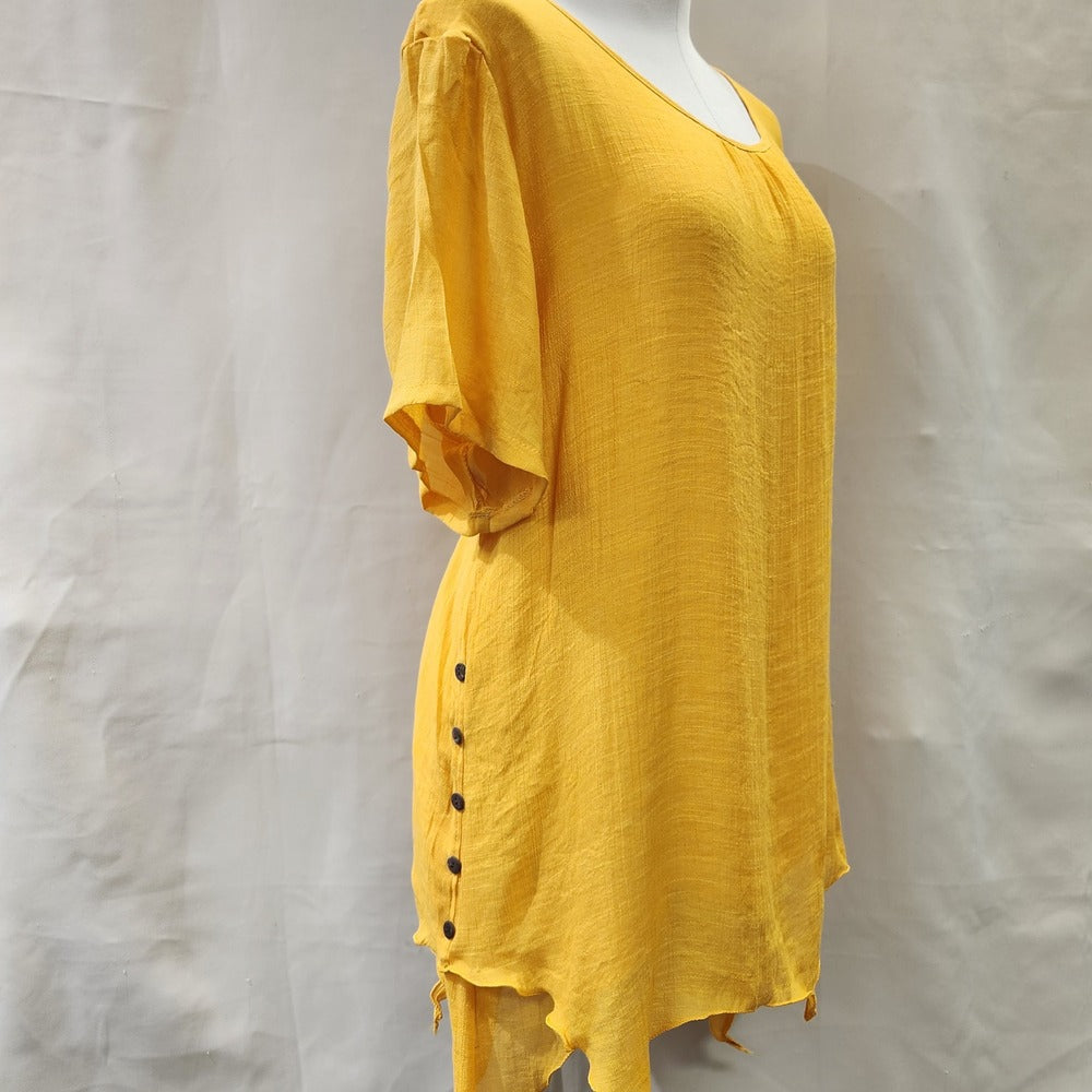Side view of short sleeve yellow layered top with pleated necknline
