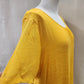 Short flowy sleeves of yellow top