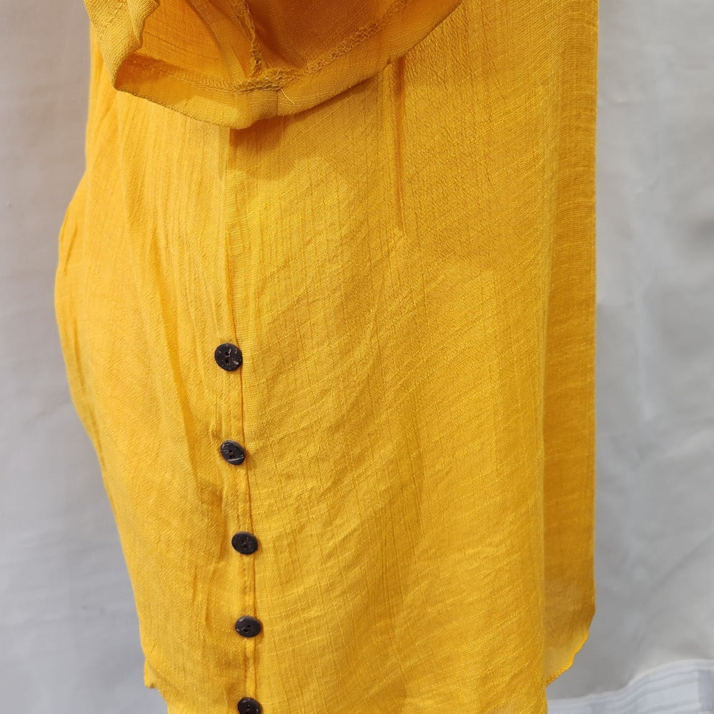 Decorative button detail on the sides of yellow top