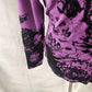 View of the sleeves of printed purple and black printed top