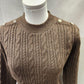 Round neckline of brown sweater