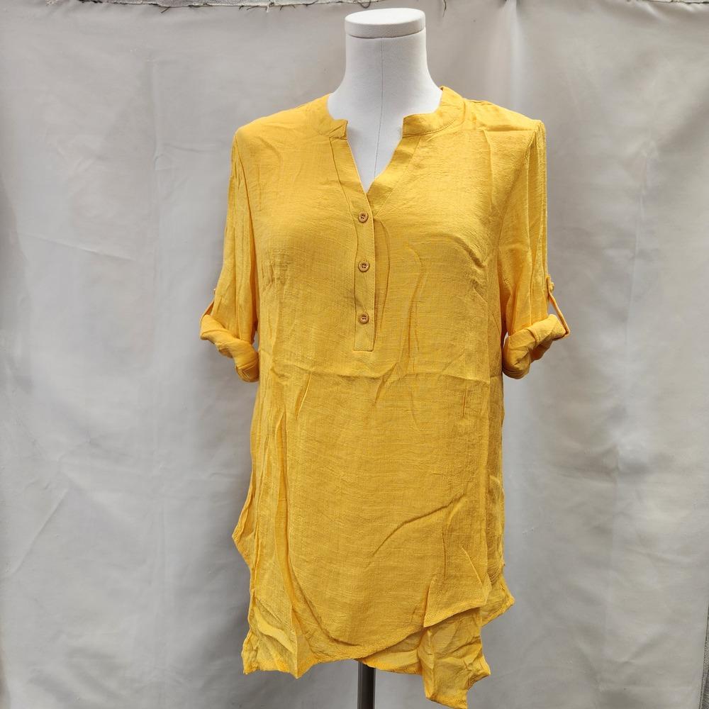 Yellow layered top with sleeves rolled up