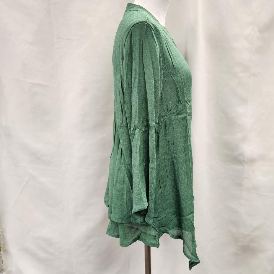 Side view of Layered green summer top with roll up sleeves