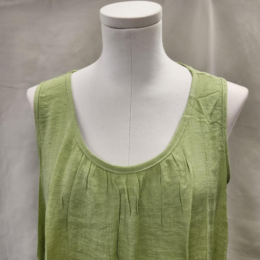 Round lightly pleated neckline of green summer top