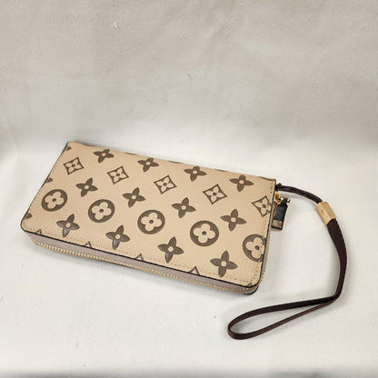 Beige wallet with brown floral design wallet with brown wrist strap