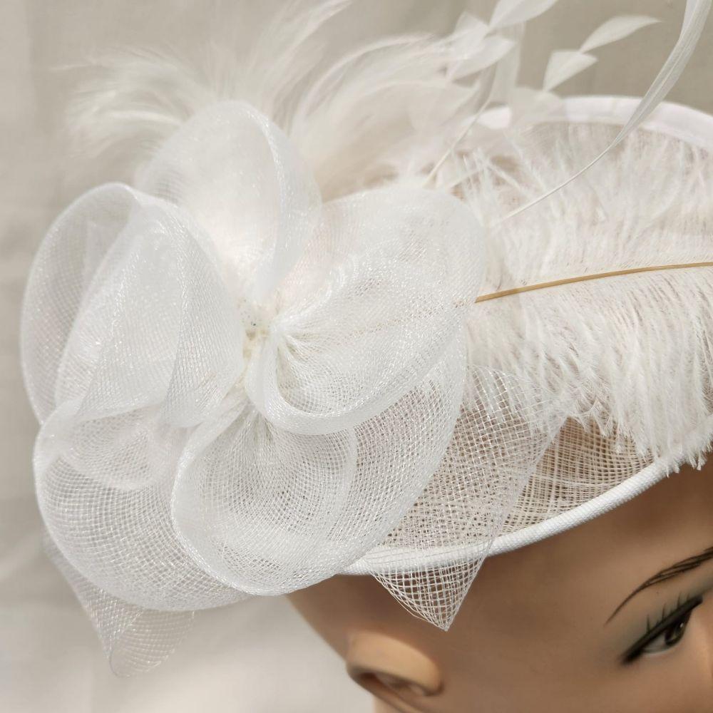 DEtailed shot of White cambric with feathers fascinator