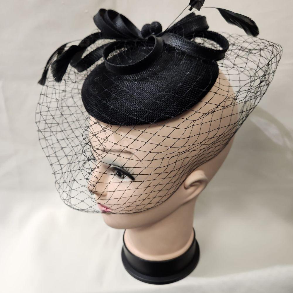 Side view of Elegant cambric fascinator in black with veil