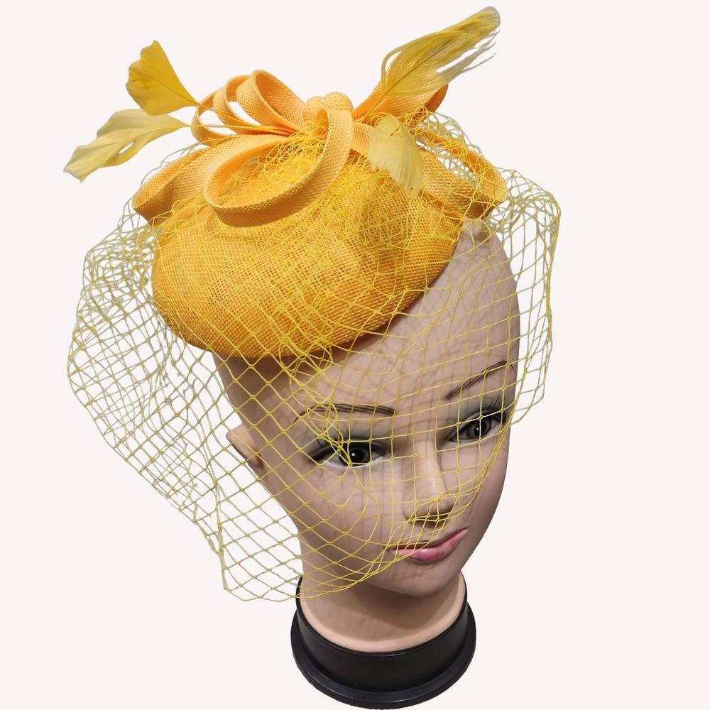 Front view of cambric fascinator in yellow with veil