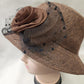 Detailed view of Cloche hat in brown