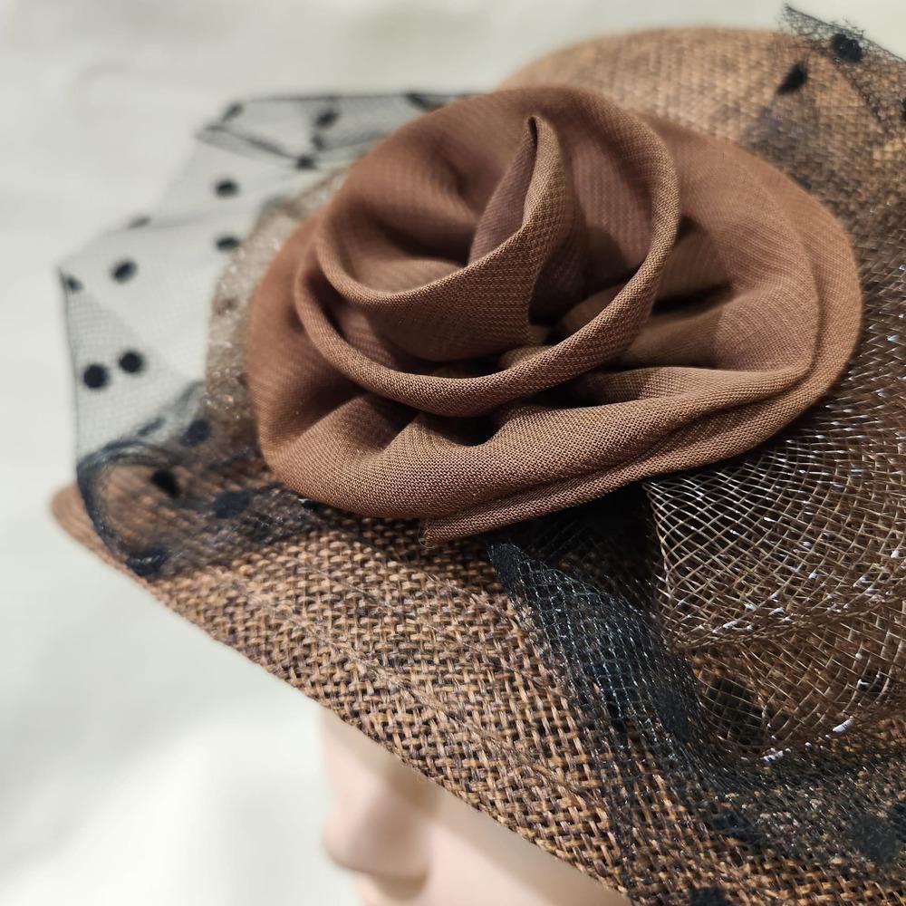 Embellishments on brown cloche hat