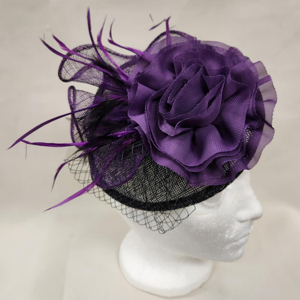 Another view of black and purple fascinator on display stand