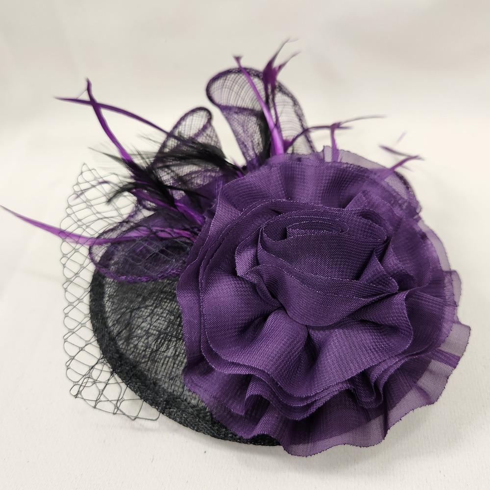 Top view of Black and purple fascinator with feathers and net 