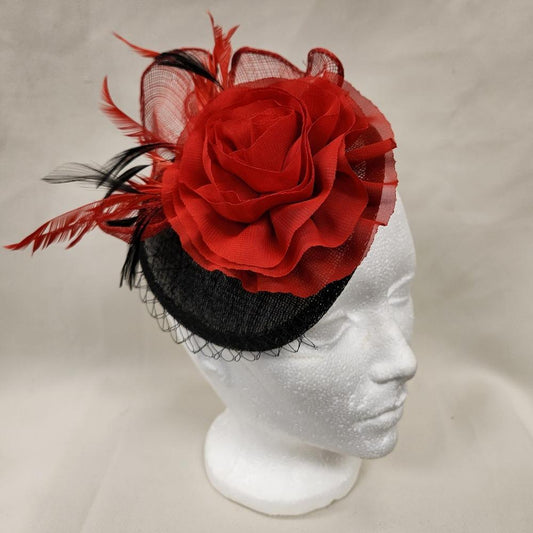 Black and red fascinator displayed on a mannequin head