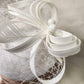 Detailed view of Elegant cambric fascinator in white with veil