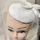 Front view of Elegant cambric fascinator in white with veil