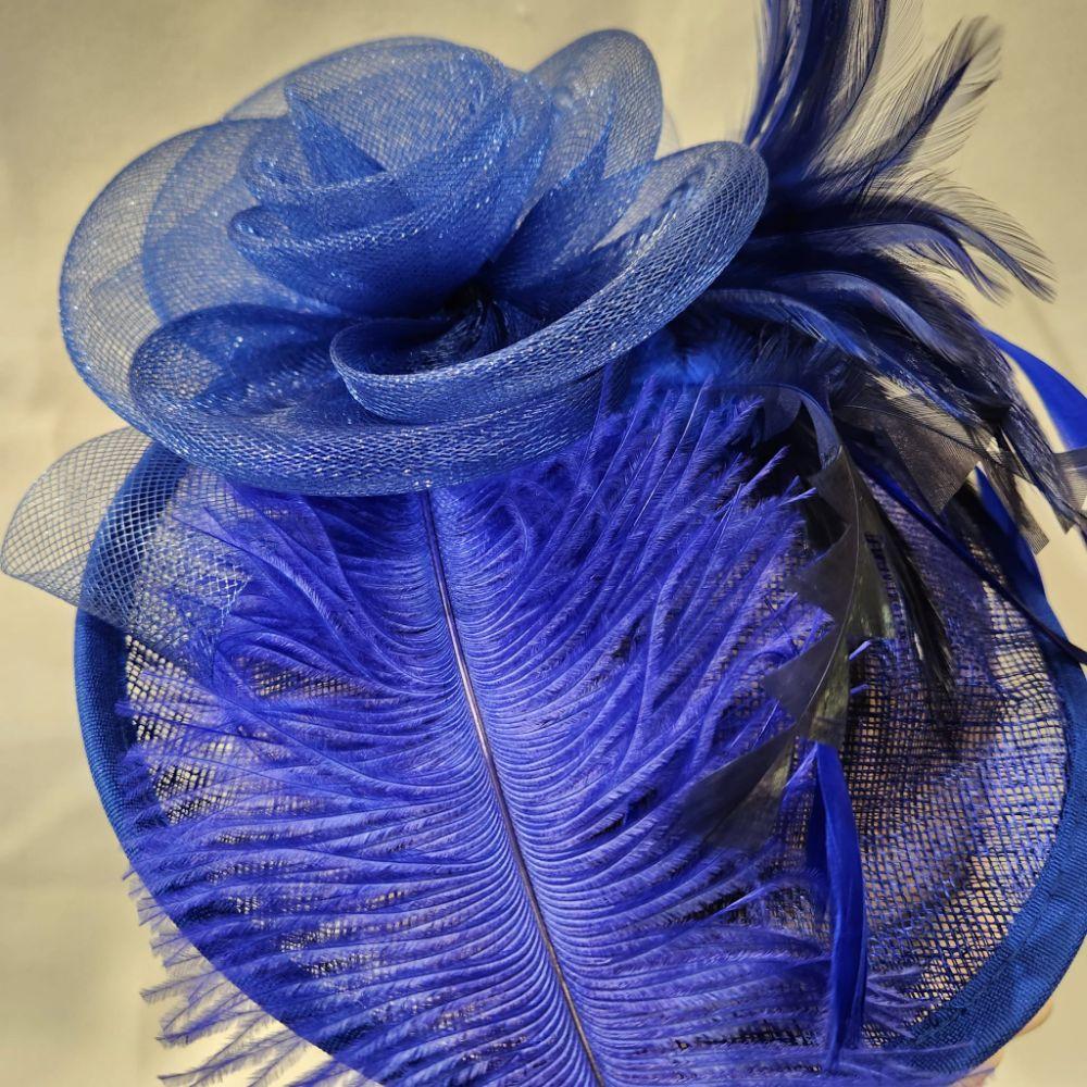 Detailed view of Blue cambric fascinator with blue and black feathers