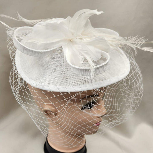 Side view of White cambric fascinator with opened up net veil