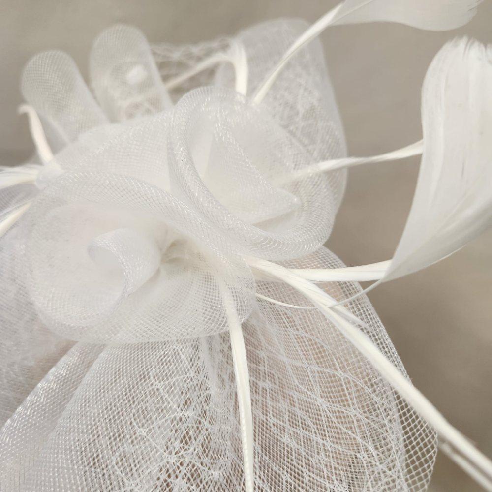 Close up view of net flower on white fascinator