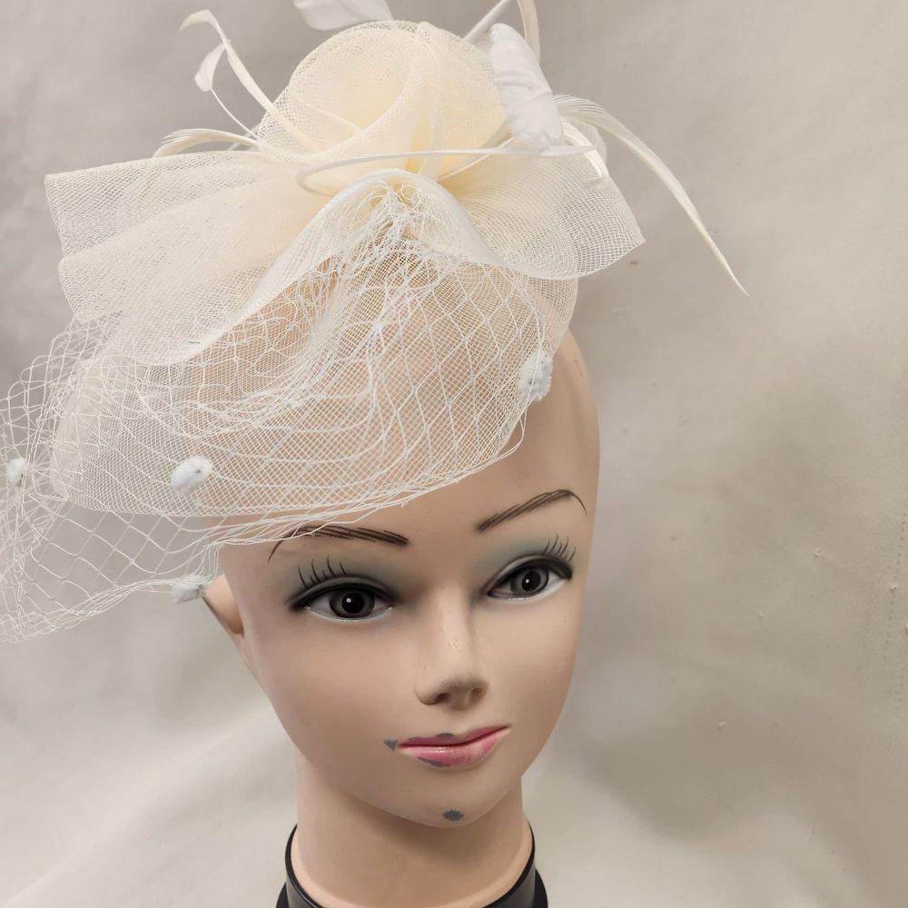 Front view of Classic cream colored fascinator with veil