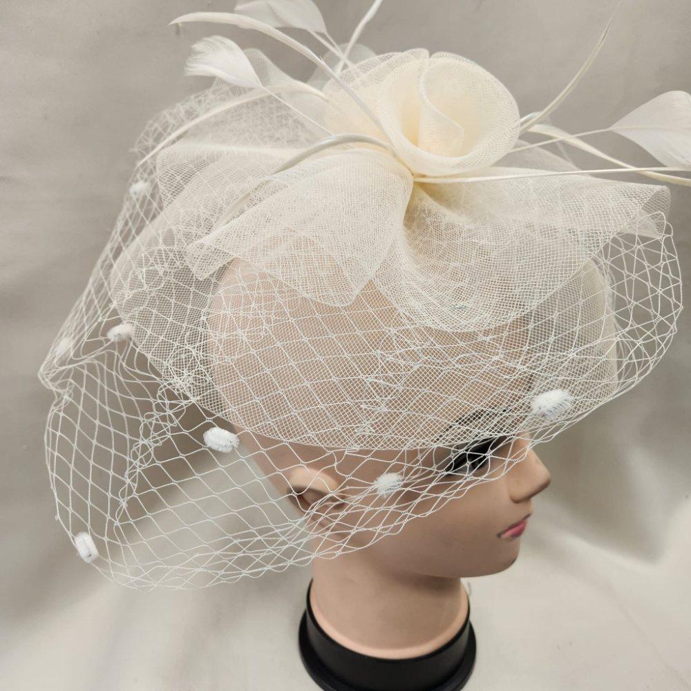 Alternative side view of Classic cream colored fascinator with veil