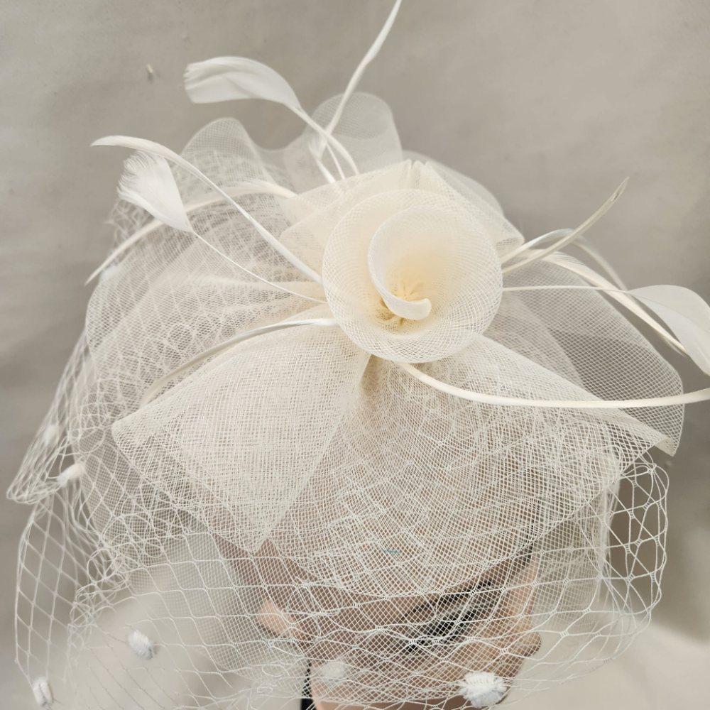 Detailed top view of Classic cream colored fascinator with veil