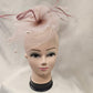 Front view of Classic dusty pink fascinator with veil