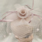 Detailed top view of Classic dusty pink fascinator with veil