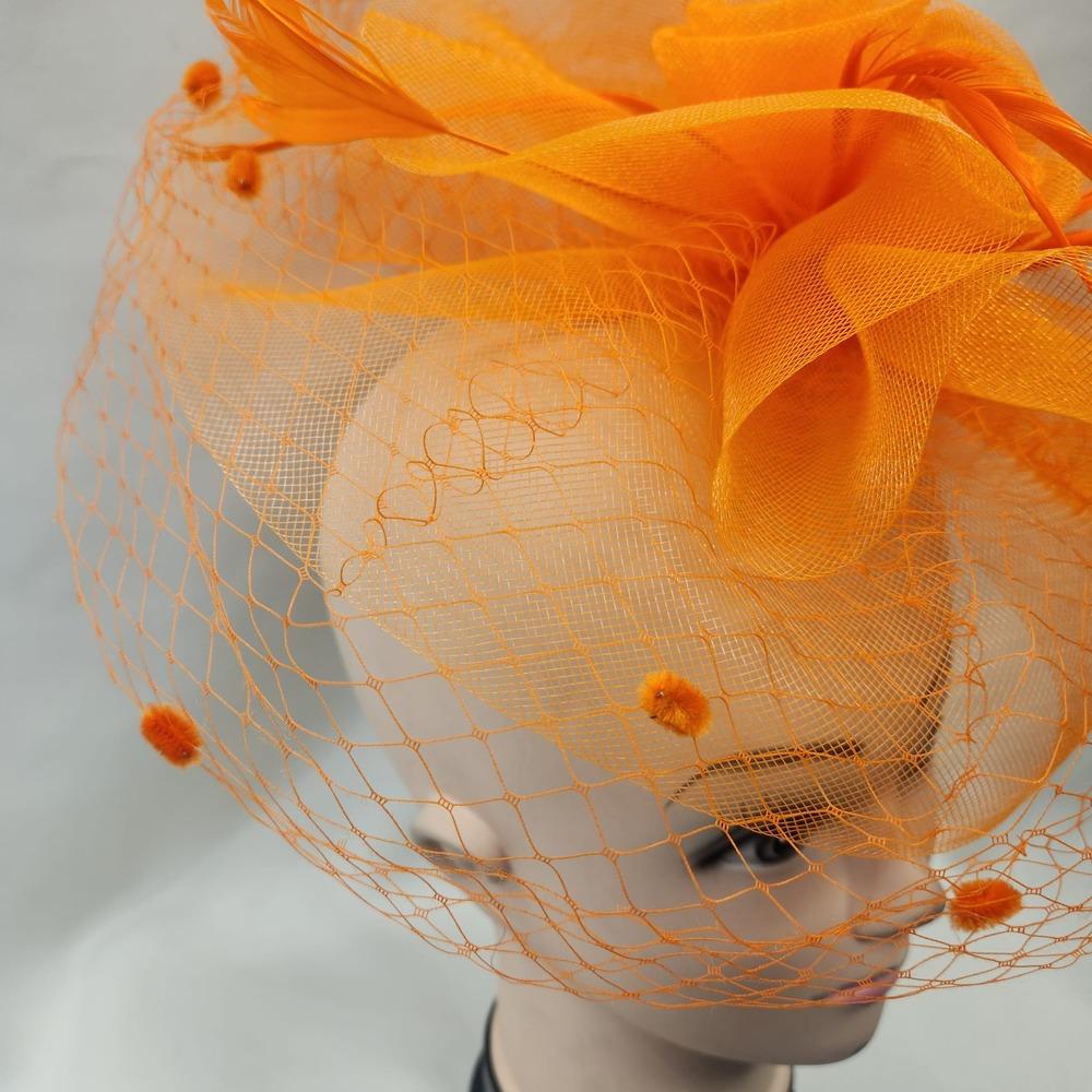 Detailed side view of Classic orange fascinator with veil