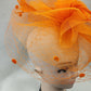 Detailed side view of Classic orange fascinator with veil