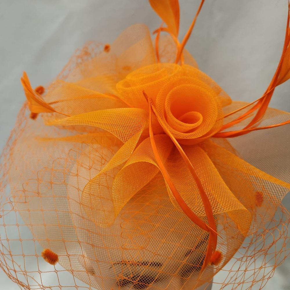 Detailed front view of Classic orange fascinator with veil