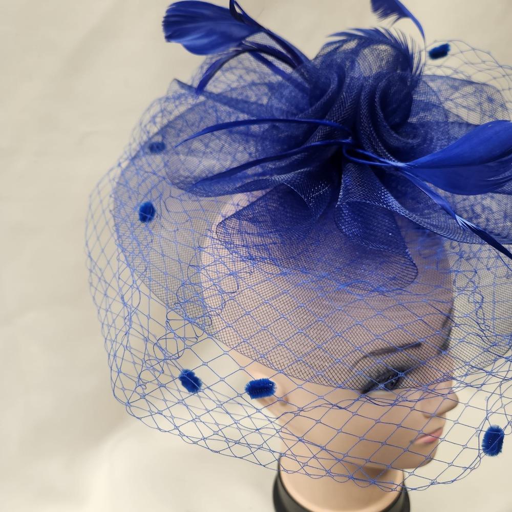 Detailed side view of Classic bright blue fascinator with veil