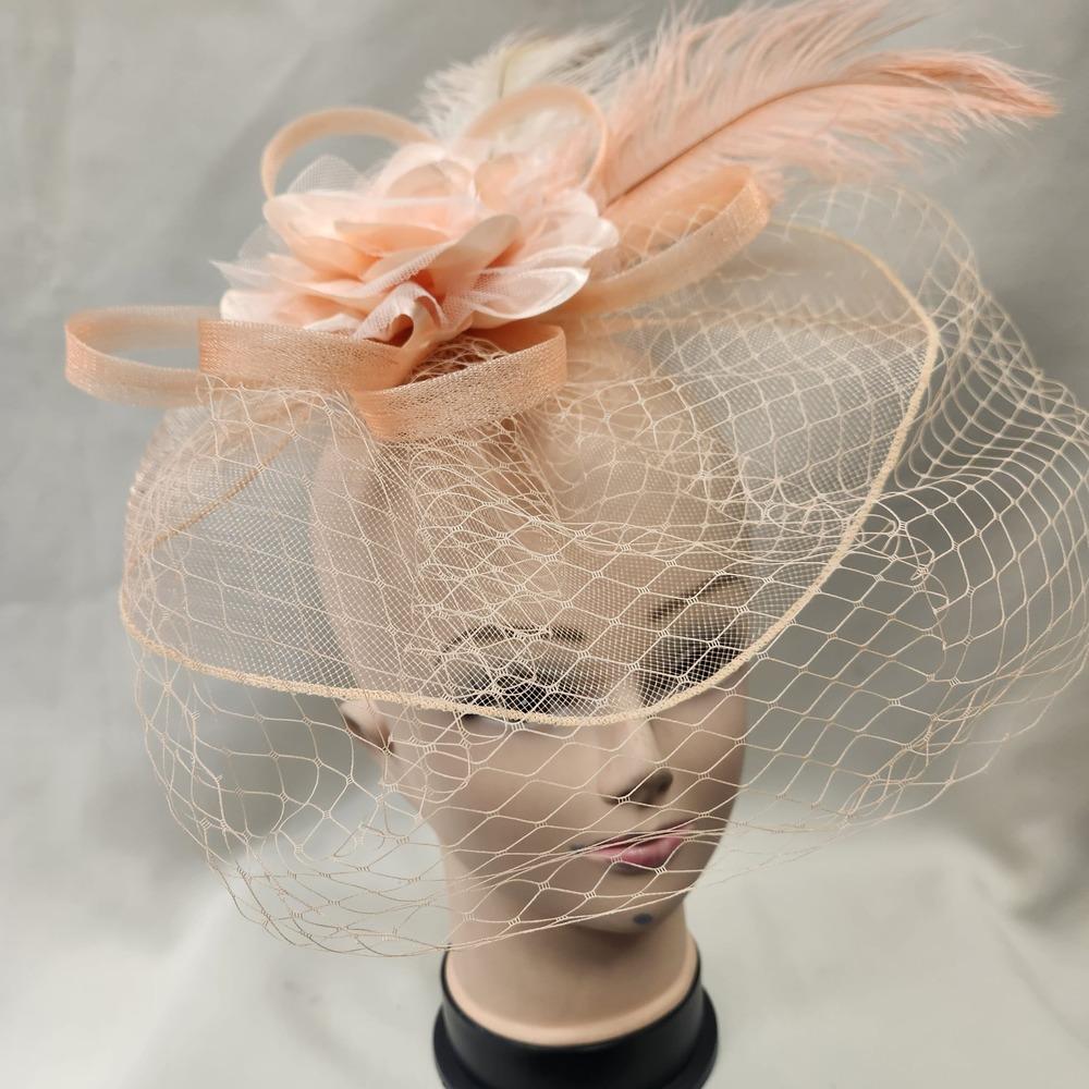 Alternative front view of Elegant peach colored fascinator with veil