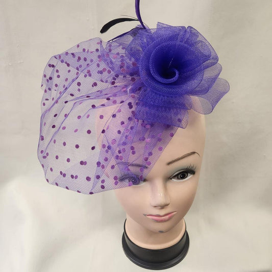 Purple fascinator with mesh and feather detail