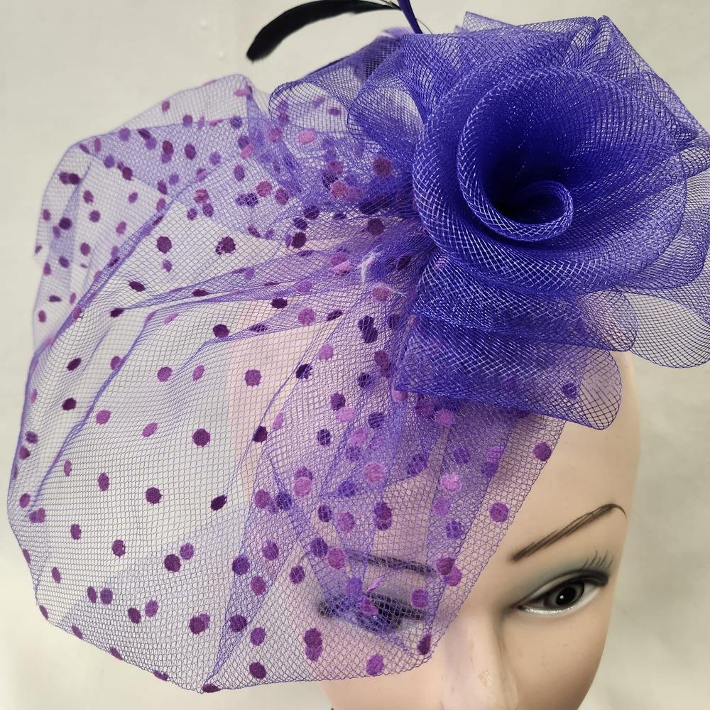 Detailed view of Purple fascinator with mesh and feather detail