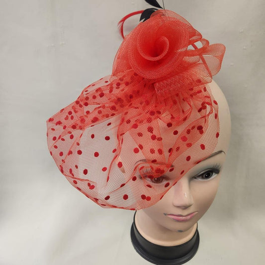 Red fascinator with mesh and feather detail
